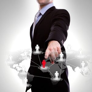 Social Network concept : business man point to social network and world map